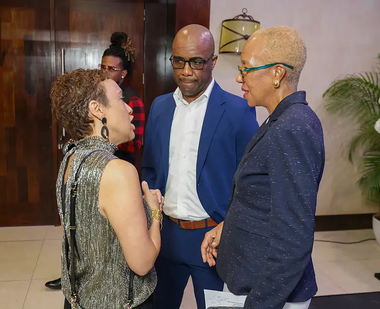 Investors networking and discussing finance strategies at a professional event, showcasing diversity and collaboration in the financial industry.