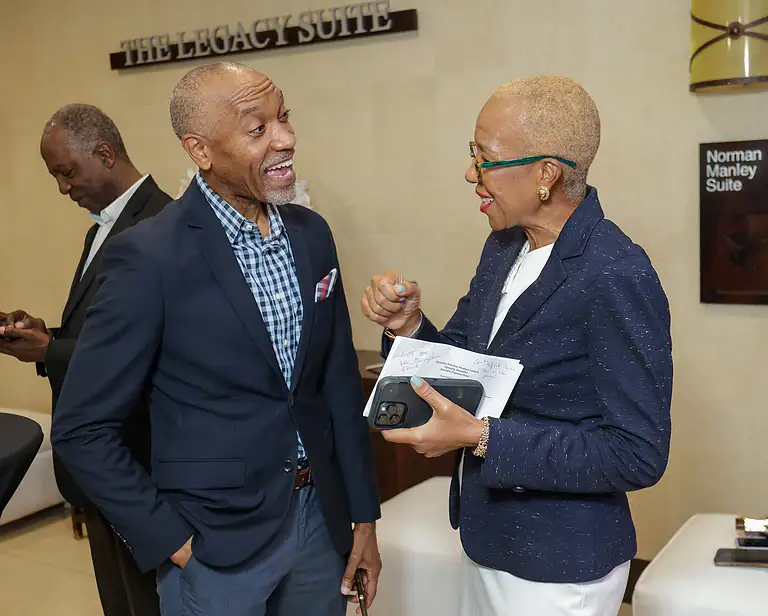 Energetic professionals discussing investment strategies at a conference; showcasing diversity, collaboration, and leadership in finance.