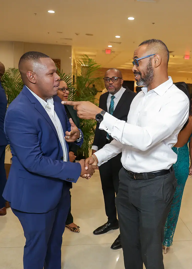 Expert handshake at a financial conference, representing professional networking and business growth in the finance sector.
